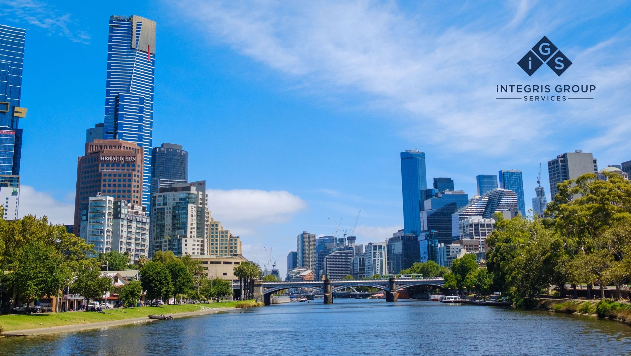 Cityscape view of Melbourne, Australia, featuring the Yarra River, lush greenery, and modern skyscrapers under a vibrant blue sky, representing streamlined water trading operations.